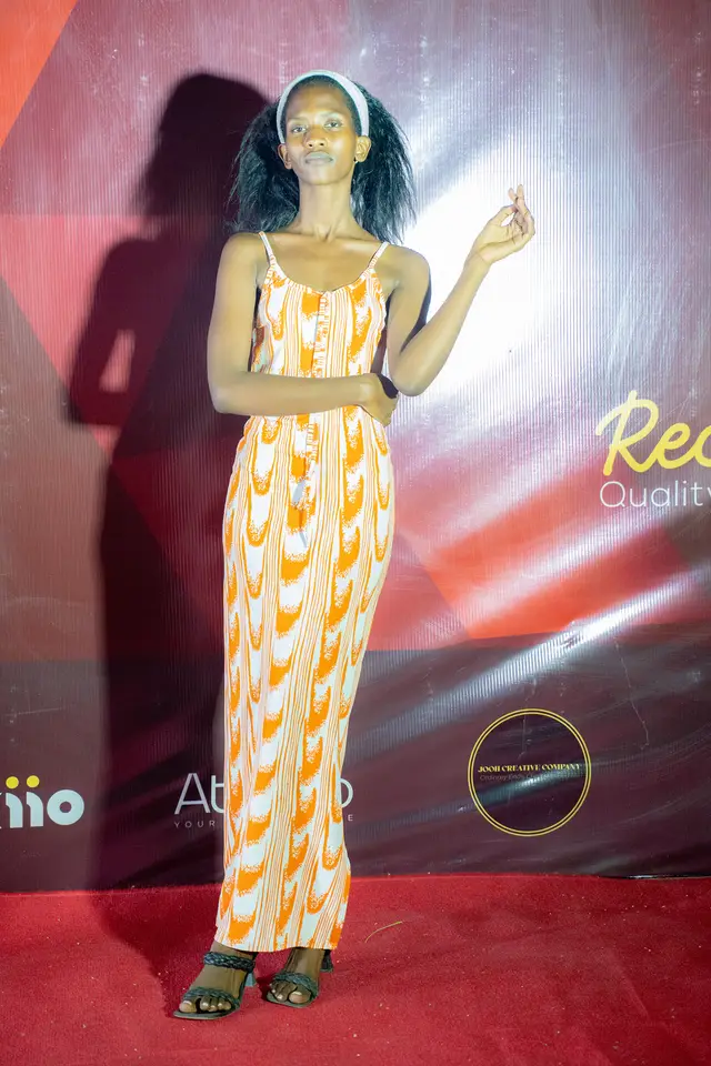 Guest in orange flame-print gown on the red carpet