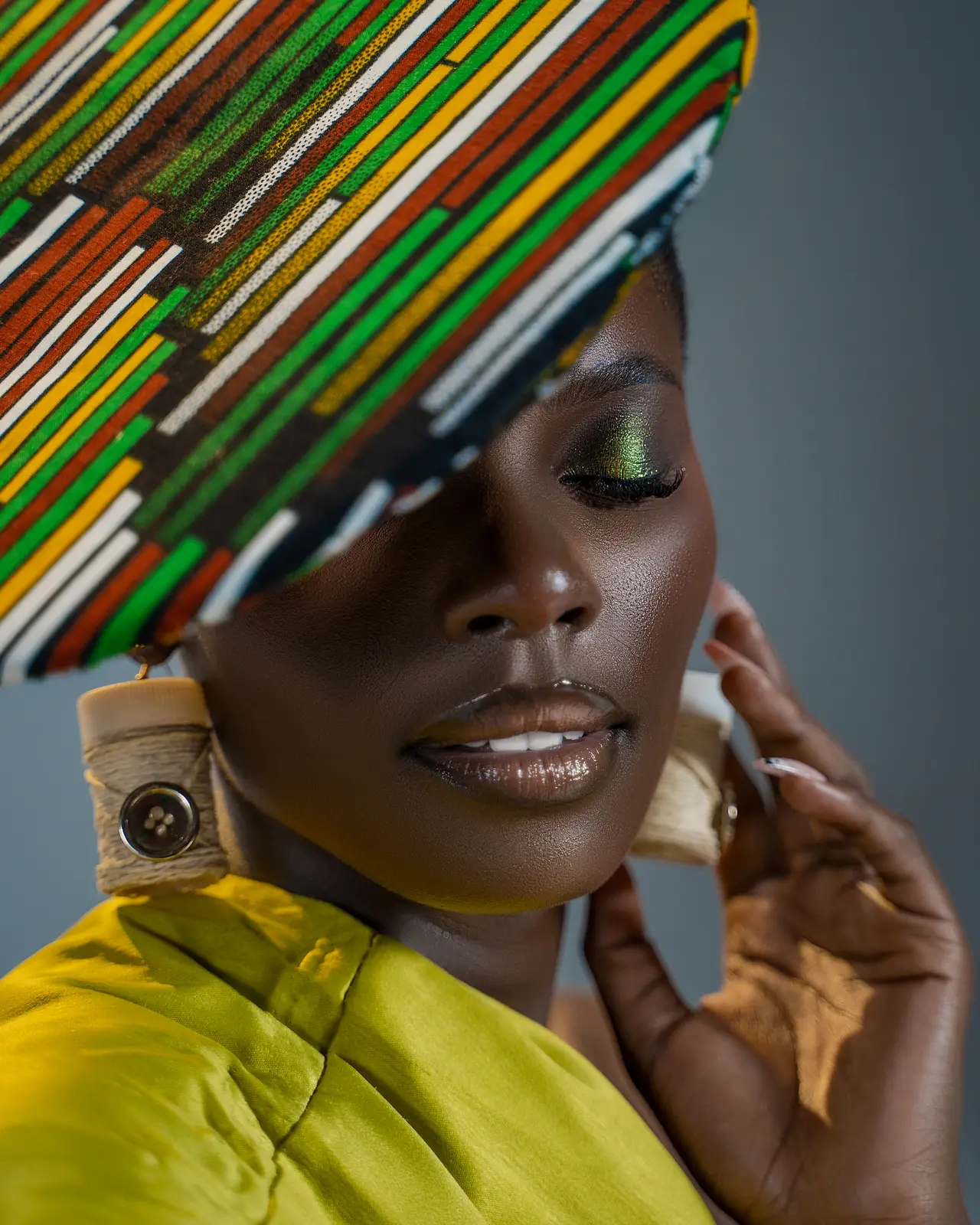 Editorial beauty portrait with African textile headwear in chartreuse
