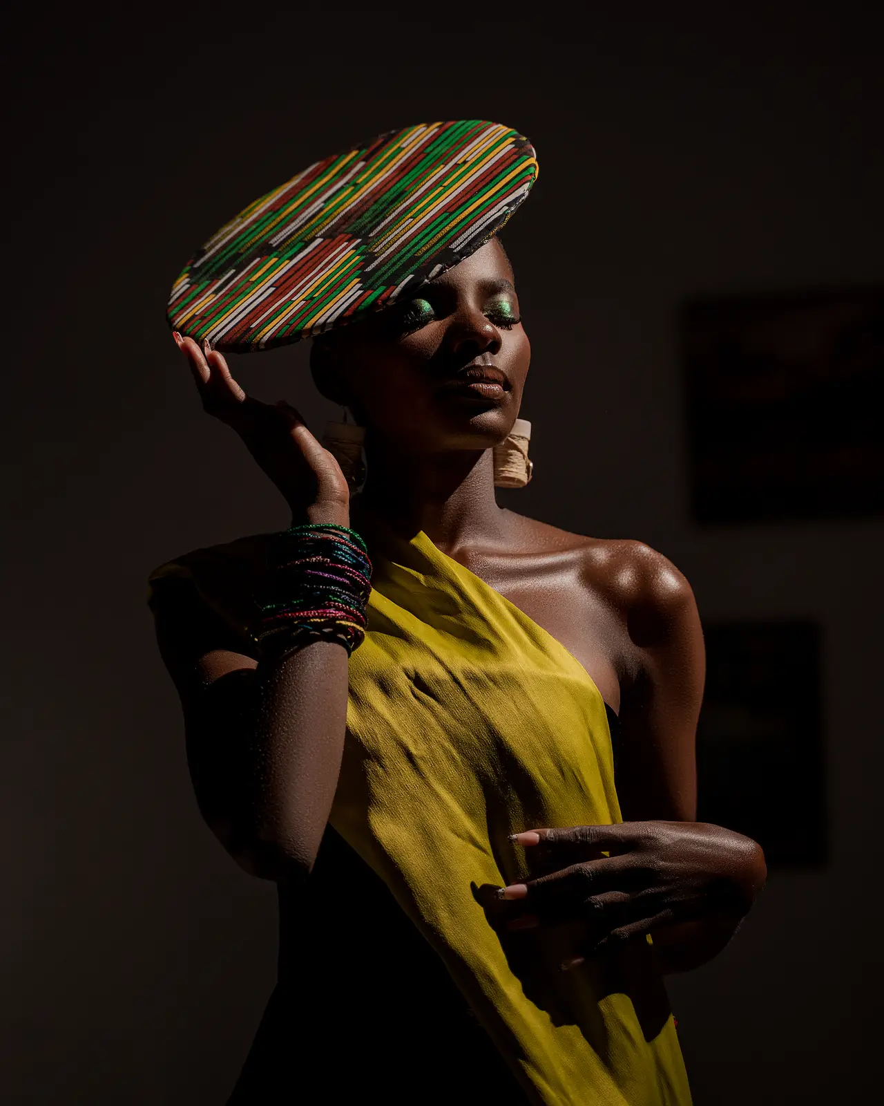 Dramatic fashion portrait in mustard yellow with striped headdress